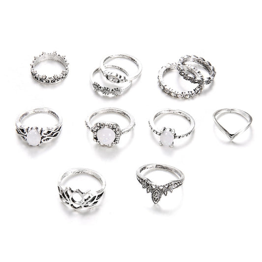 Silver-tone ring set with opal-style stones and filigree detailing, 11-piece assortment
