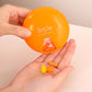 Orange 7-day rotating pill container held open with pills inside