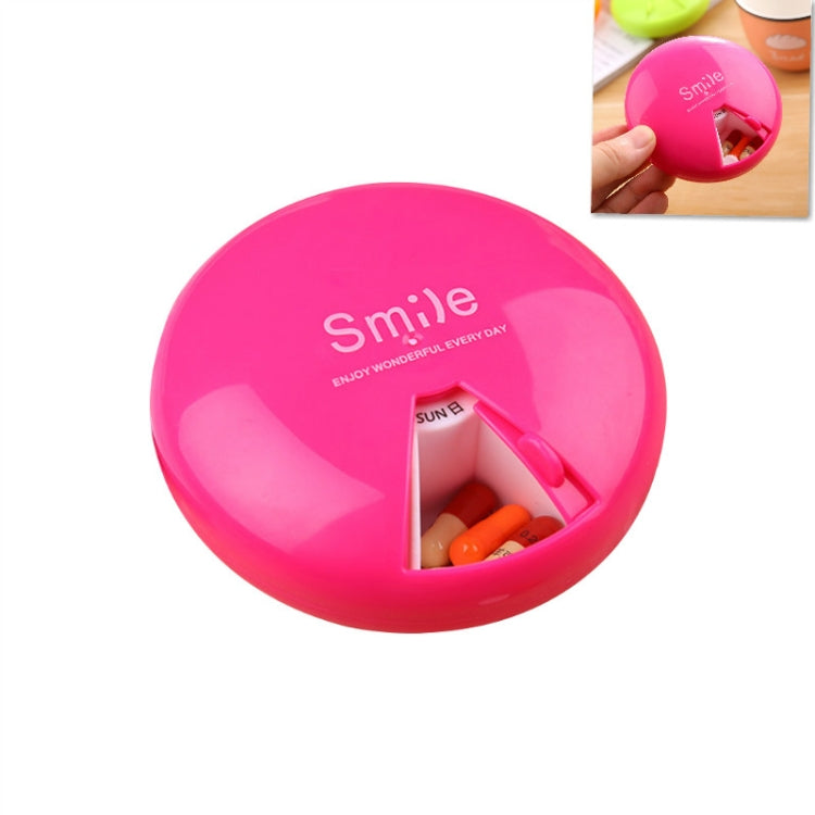 Rose red 7-day rotating pill container with open compartment and orange capsules