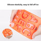 Orange silicone letter ice cube tray with A–Z molds held in hand
