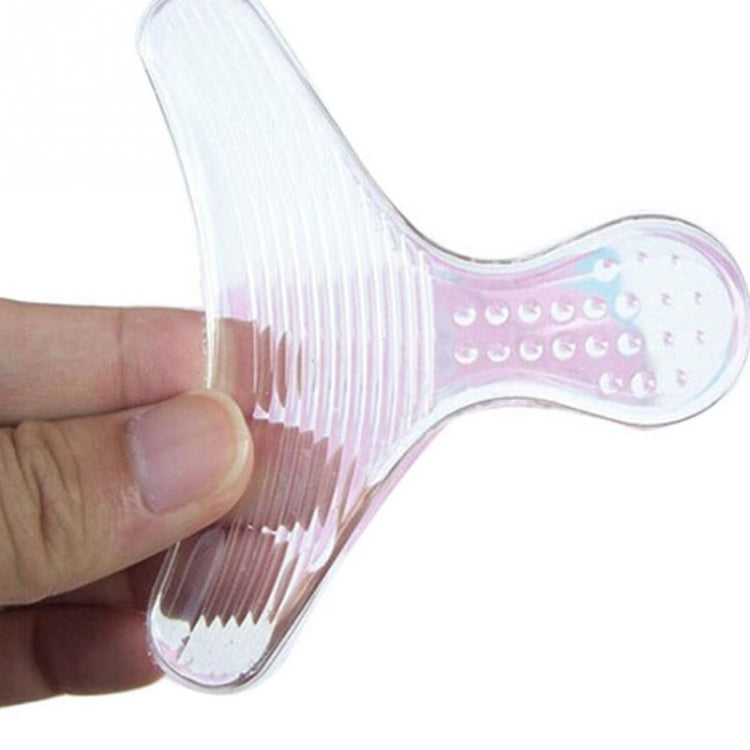 Clear T-shaped silicone insole sticker in hand with small grip dots on pad