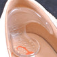 Clear T-shaped insole sticker close-up inside a high-heel shoe