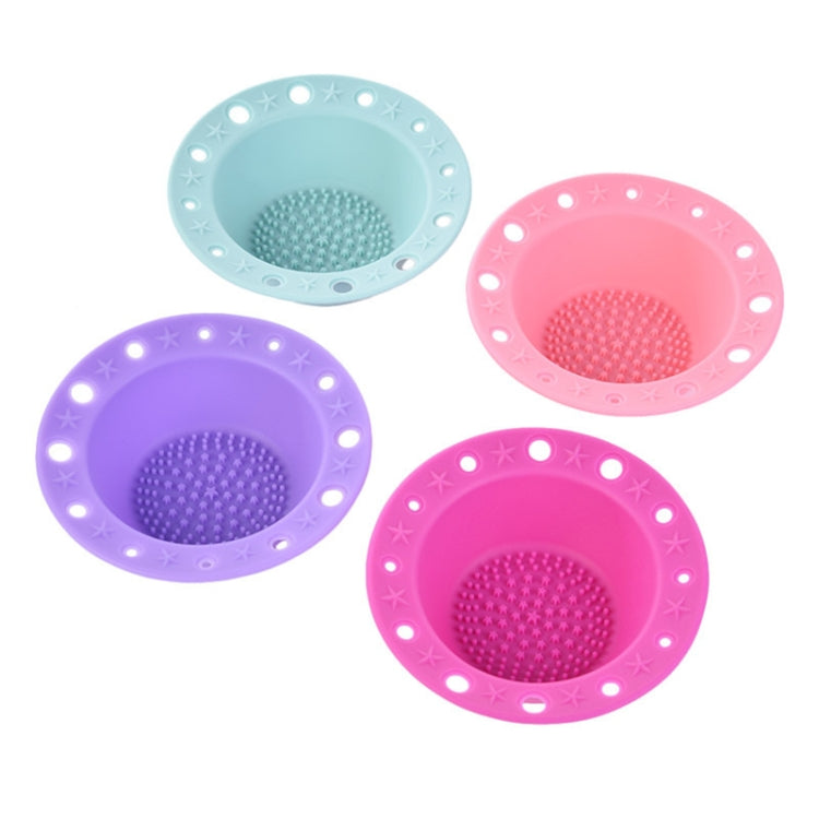 Set of silicone makeup brush cleaning bowls in blue, purple, and pink with textured pads.