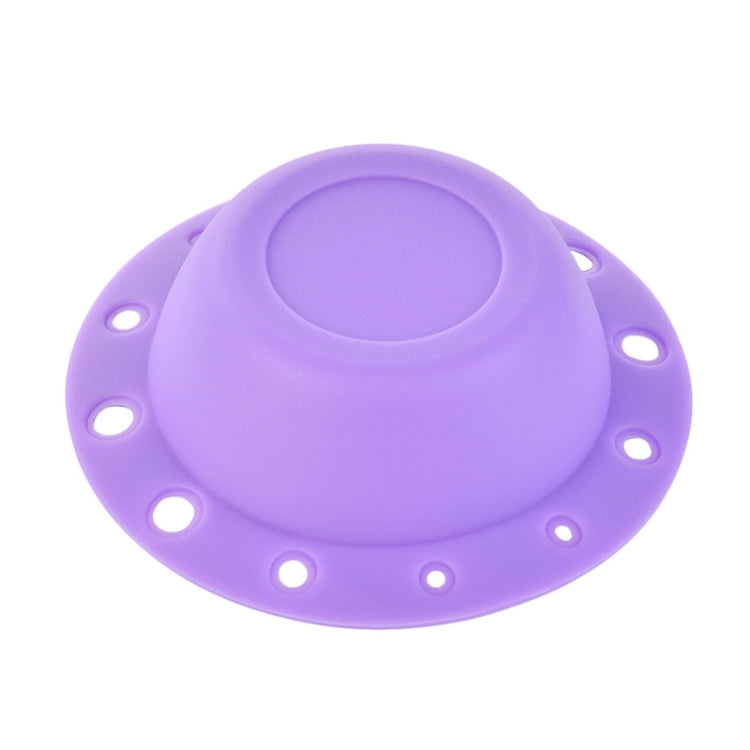 Purple silicone makeup brush cleaning bowl with central textured scrubbing pad and rim holes.
