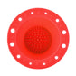 Red silicone makeup brush cleaning bowl with central textured scrubbing pad and rim holes.