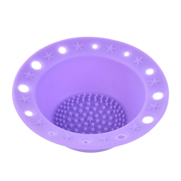 Lavender-purple silicone makeup brush cleaning bowl with textured scrubbing pad and rim holes.