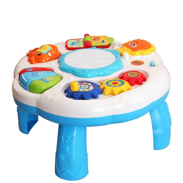 White kids musical drum table with colorful activity gears, buttons, and light center