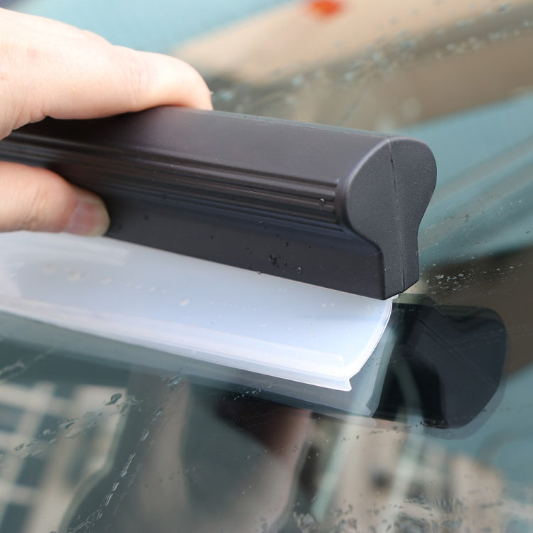 Black-and-white water scraper squeegee blade pressed to car window