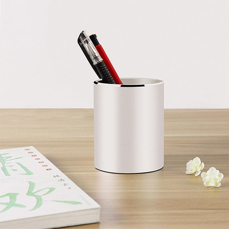 White round aluminum pencil holder with red and clear pens inside