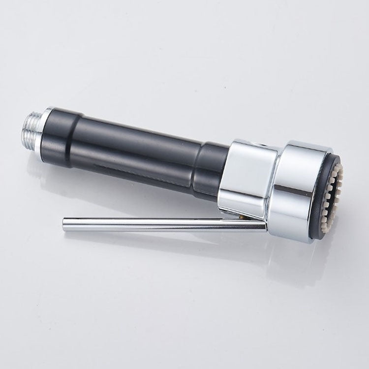 Chrome and black handheld faucet nozzle with extended spray disc at the tip