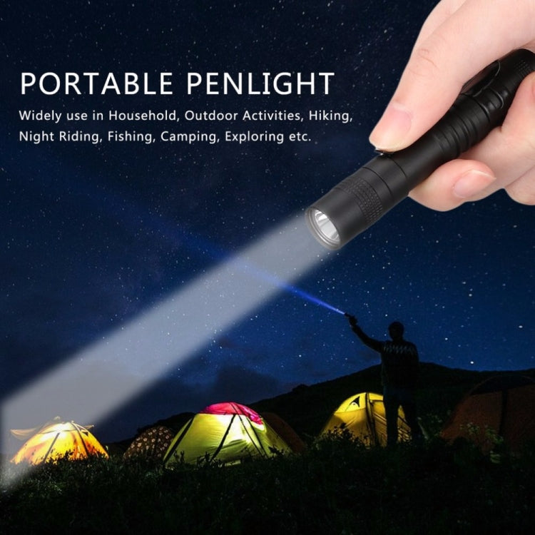 Black portable penlight LED flashlight held by a hand