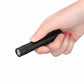 Black penlight LED flashlight held in hand with textured grip