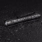 Black pen-shaped LED flashlight on wet surface with water droplets