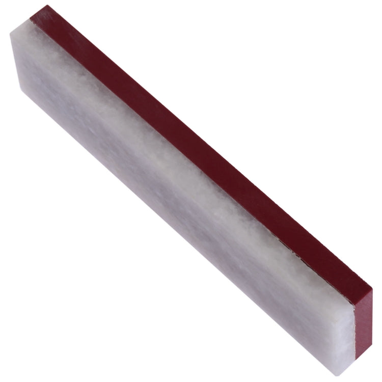 White sharpening stone with maroon side strip, angled view