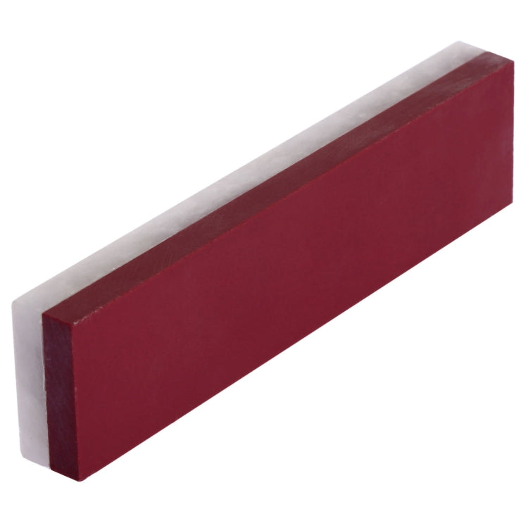 White and maroon sharpening stone block, end-on view
