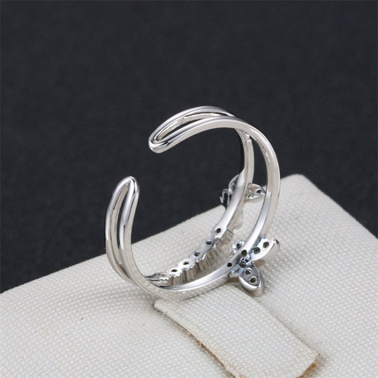 Platinum butterfly diamond opening ring, side view of curved stacked bands