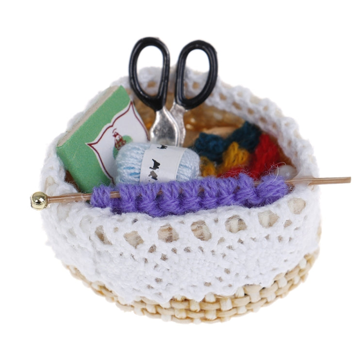 Mini dollhouse knitting tool basket with black scissors, needle, and yarn balls