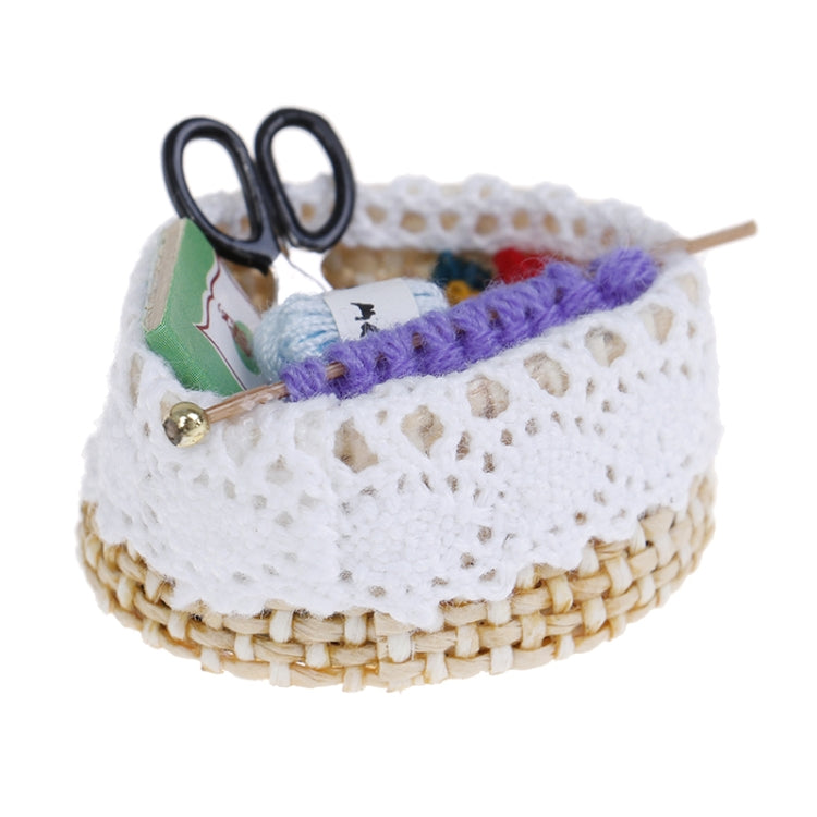 Mini dollhouse knitting tool basket with black scissors and purple yarn across white lace rim