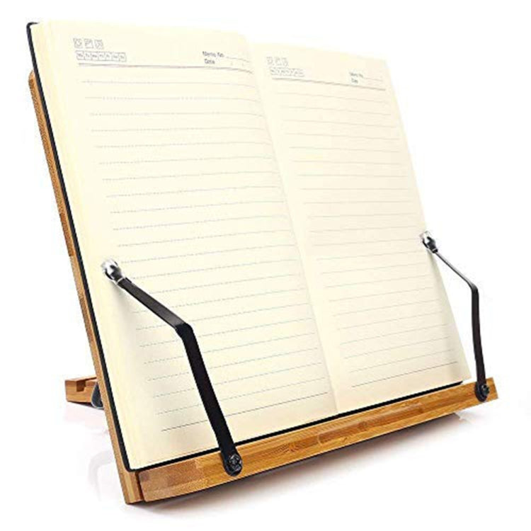 Bamboo book stand holding an open notebook with black securing clips