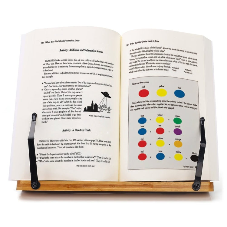 Bamboo reading stand holding an open book with colorful diagrams and black clips