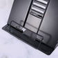 Black metal book stand base with adjustable clamps and angled back plate