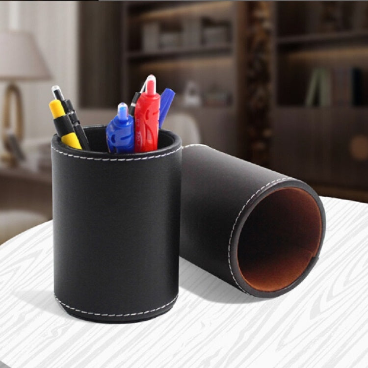 Black faux-leather pen holder organizer with open side, holding colored pens and markers.