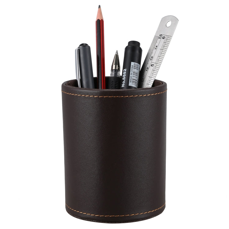 Brown faux-leather pen holder organizer, round cylinder with tan interior and desk supplies.