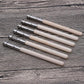 Wood pencil extenders with silver metal ferrules on light wood bodies