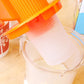 Manual soybean juicer strainer insert in clear jug with orange press mechanism