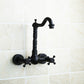 Wall-mounted bathroom faucet, black antique finish, curved spout and cross-style control knobs