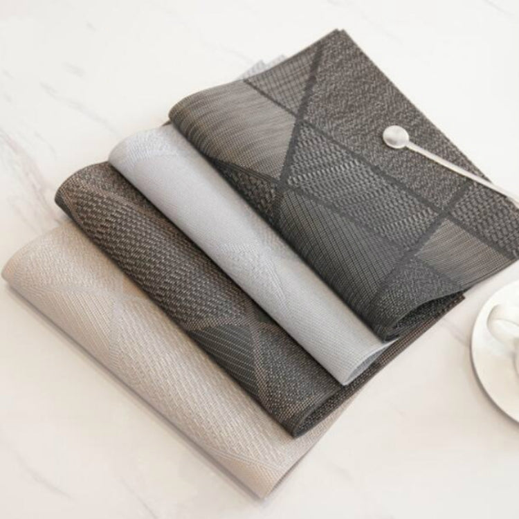 Set of folded table mats in dark gray and light gray, with textured woven surface.