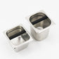 Two stainless steel coffee grounds containers with black scoop handles, different sizes
