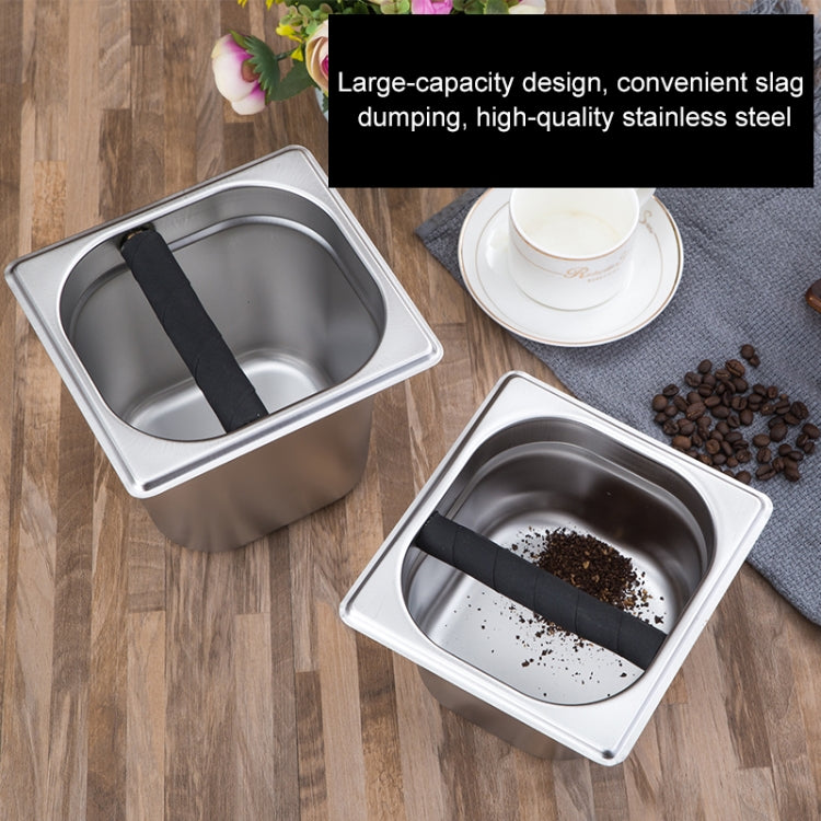 Stainless steel coffee grounds bucket with black scoop handle, coffee grounds inside
