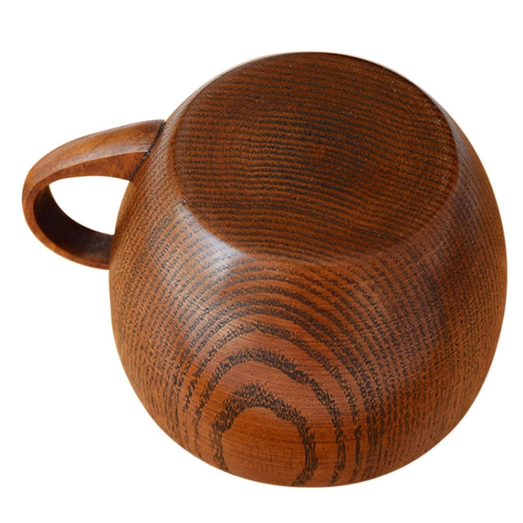 Brown wooden mug cup with handle, rounded bowl, wood grain texture