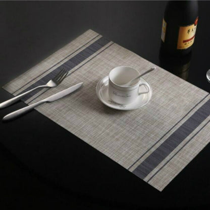 Braided PVC table mat with navy stripe border and checkered center, 30x45cm