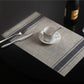 Braided PVC table mat with navy stripe border and woven-style center, 30x45cm
