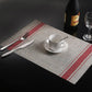 Braided PVC table mat with red stripe border and woven-style center, 30x45cm