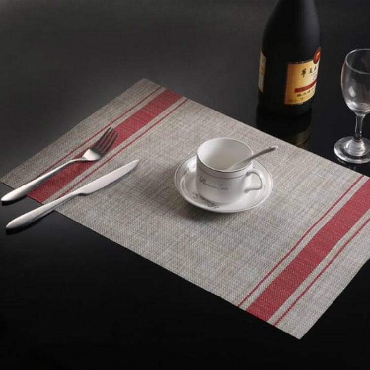 Braided PVC table mat with red stripe border and woven-style center, 30x45cm