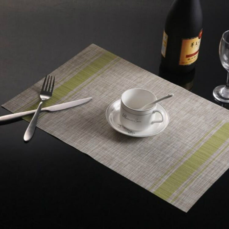 Braided PVC table mat with lime green stripe border and woven-style center, 30x45cm