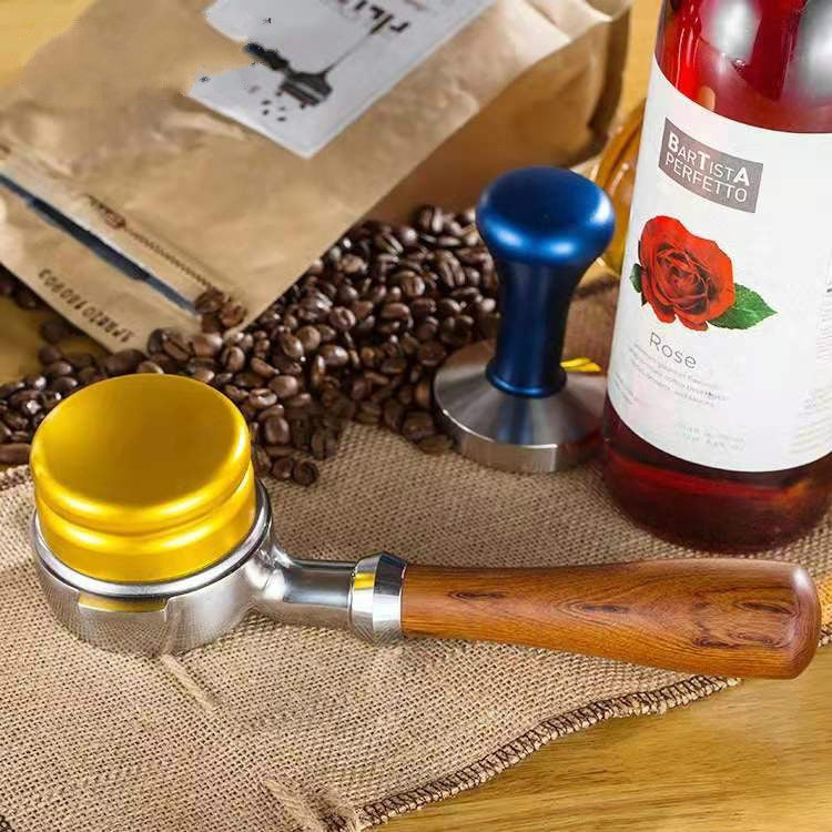 Wood-handled stainless coffee filter holder with metal base on burlap