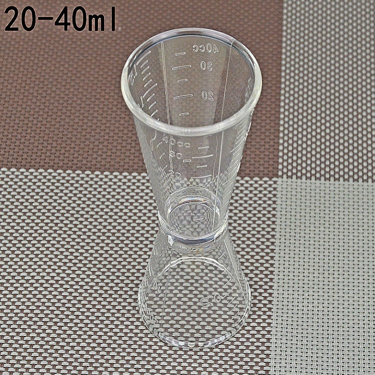 Large double-headed graduated measuring cup, clear plastic with volume markings