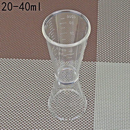 Large double-headed graduated measuring cup, clear plastic with volume markings