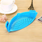 Blue silicone pot filter clip with perforated bowl shape for draining liquids while cooking