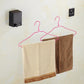 Retractable clothesline system with towels hanging on hangers from a wire line
