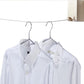 Retractable clothesline wire with two shirts hanging on metal hangers