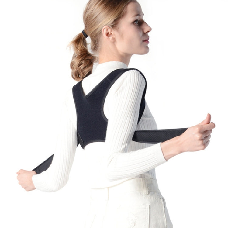 Black back correction strap with shoulder straps on a woman, side view