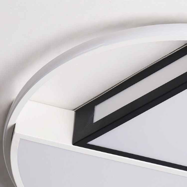 Ceiling lamp detail: white circular frame with black center strip and light panel