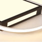 Ceiling lamp close-up with glowing warm light and black geometric inner bars