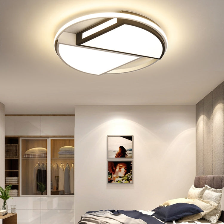 Warm white ceiling lamp in modern room with round ring and geometric inner bars