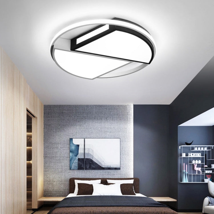Bright white ceiling lamp with circular ring and black geometric inner light bars